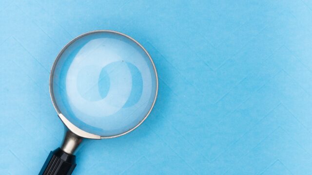 magnifying glass on blue textile