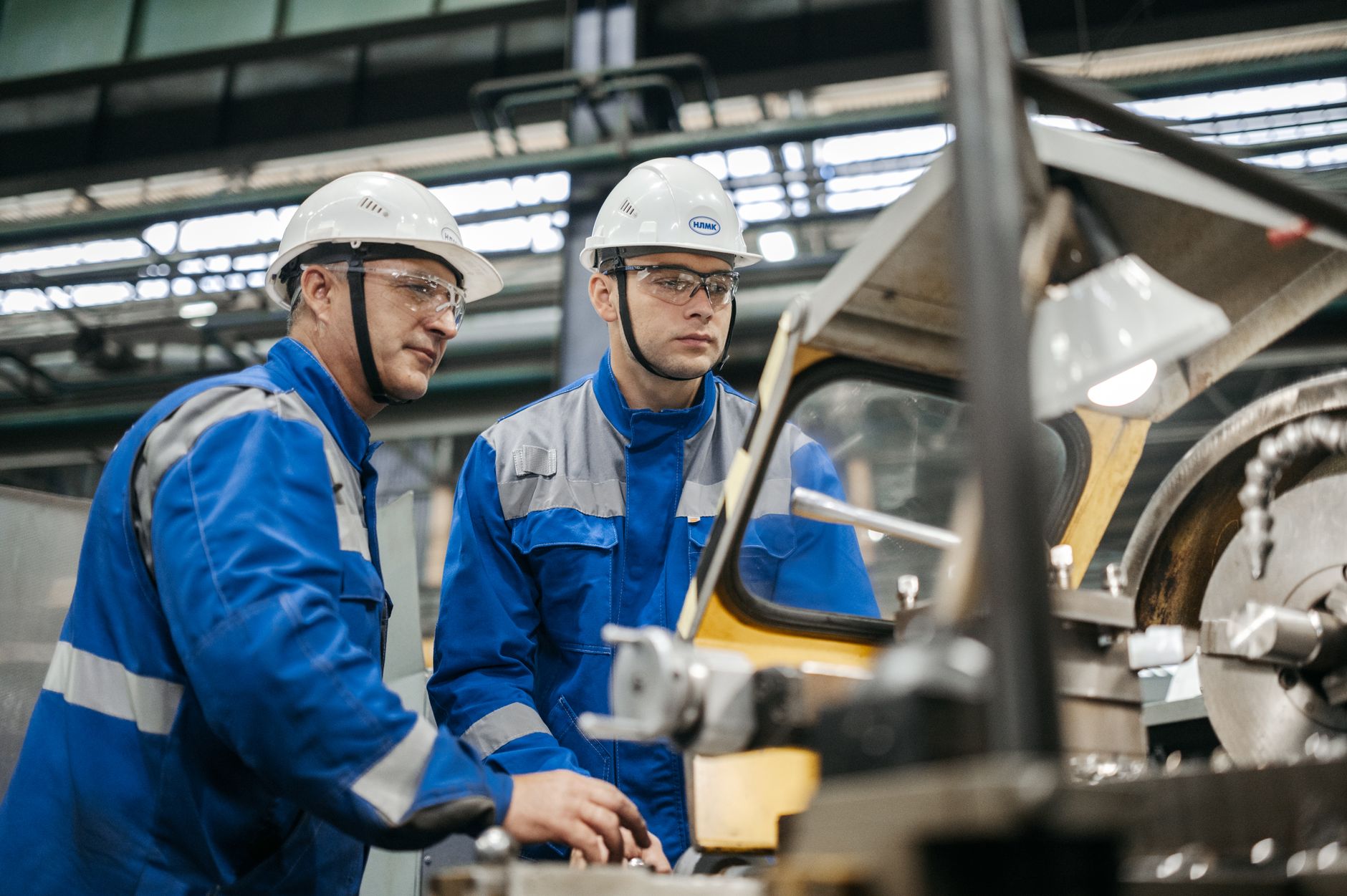 industrial workers operating machinery indoors